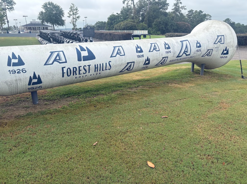Close-up of the cleaned Forest Hills Golf Club monument showing Augusta University and 1926 logos