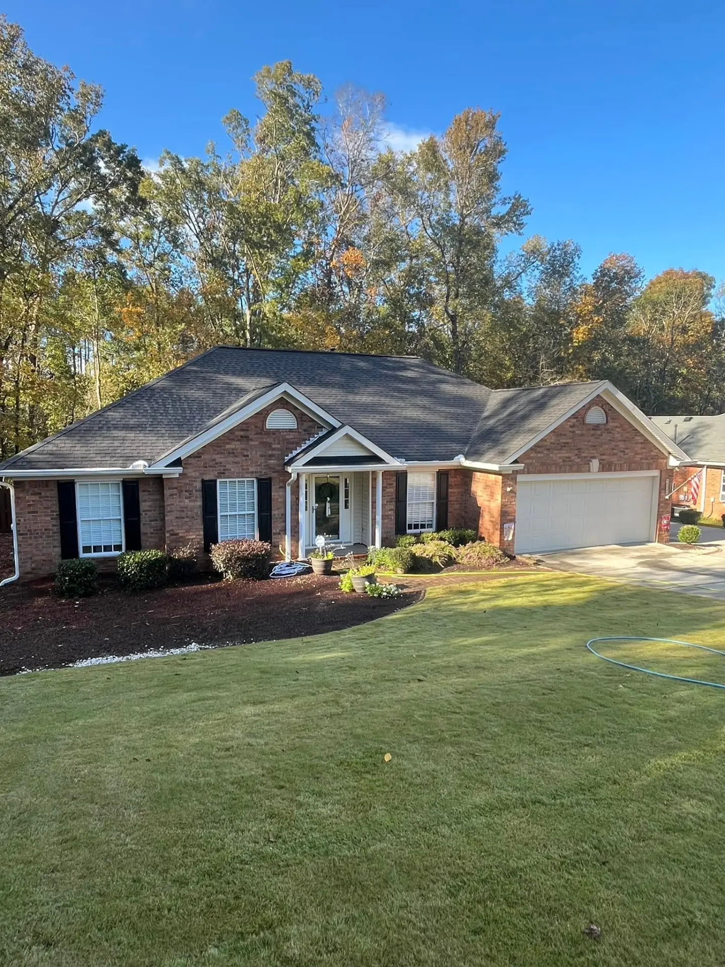 Brick Ranch Home Exterior — drag to compare — after cleaning by FloPro Pressure Cleaning