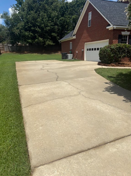 Concrete Driveway — drag to compare — after cleaning by FloPro Pressure Cleaning